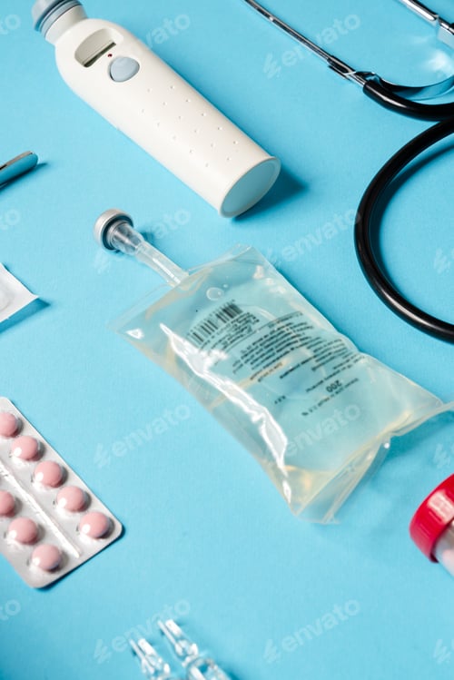 Preview: The close-up view of medical instruments consisting of a liquid container, thermometer, pills