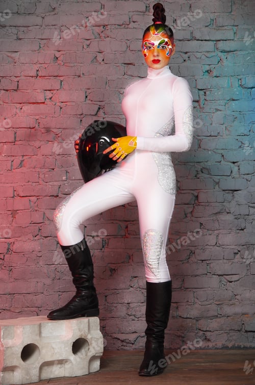Preview: Beautiful young model with bright creative make up with helmet