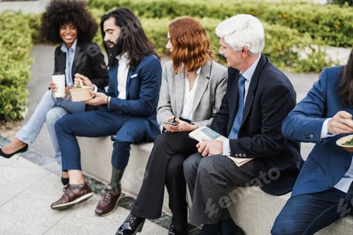 Preview: Diverse business people doing lunch break outdoor from office building - Focus on senior man face