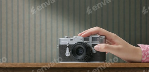 Preview: Woman holding a vintage camera