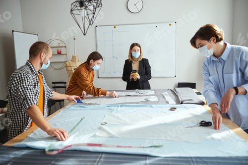 Preview: Professional tailor watching over a group of students