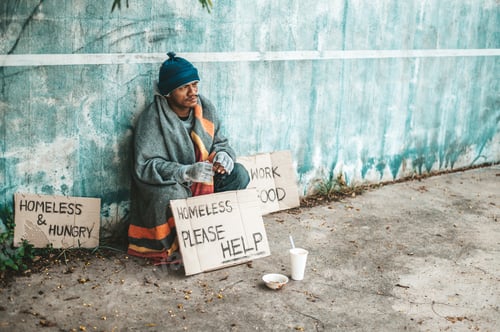 Preview: The beggars sat beside the street with a homeless message. Please help and work with food.