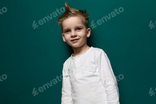 Preview: Young Boy Standing in Front of Green Wall