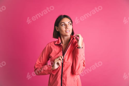 Preview: Young fit woman in sport wear jacket on pink background