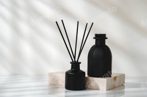 Preview: Elegant Aroma Diffuser With Black Reeds on a Marble Stand in Soft Daylight