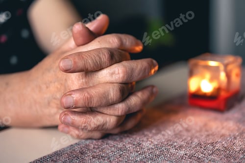 Preview: Hands of an old woman folded for prayer.
