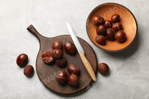 Preview: Fresh edible sweet chestnuts and knife on grey table, flat lay