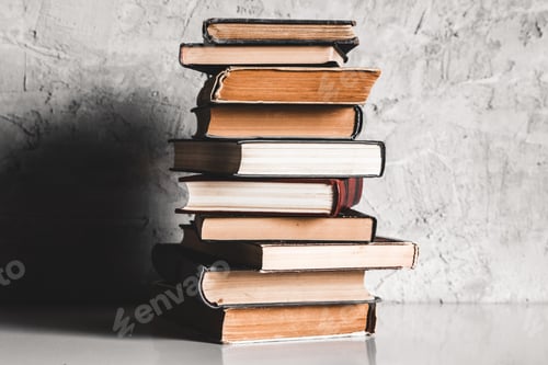 Preview: Education and reading concept, group of old colorful books on the white table on the gray background