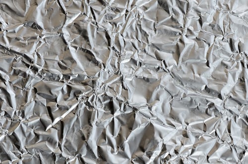 Preview: Thin wrinkled sheet of crushed tin aluminum silver foil background with shiny crumpled