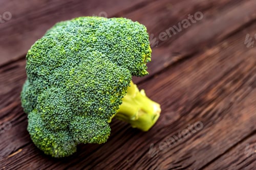 Preview: Green fresh broccoli on dark wooden surface