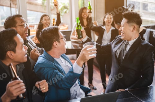 Preview: Businessmen and women are smiling and clanging glasses of alcoholic of beer