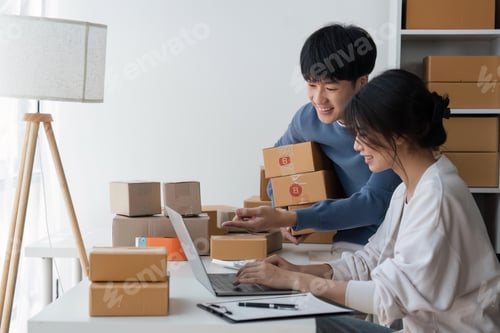 Preview: Couple of asian teenager owner business people work at home for online shopping, checking the order
