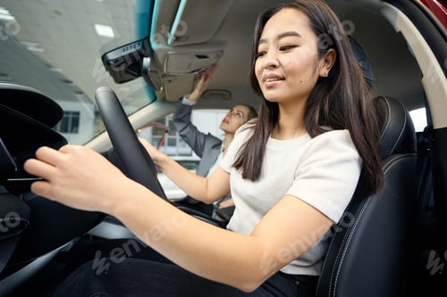 Preview: Happy woman on the driver's seat of a car