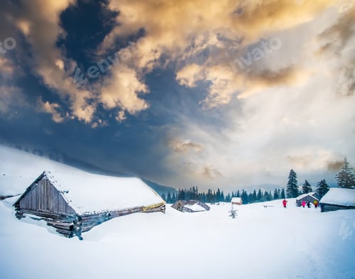 Preview: Panorama of wooden chalets at sunset