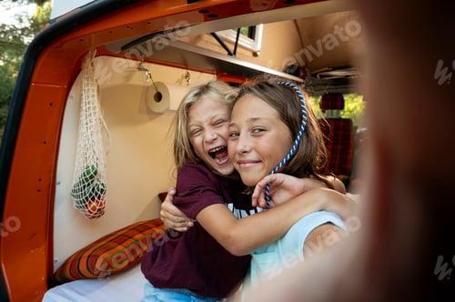 Preview: Happy children take a self on a wonderful day at camp. Van life concept.