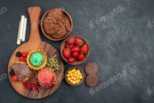 Preview: top view tasty creamy cakes with biscuits and fruits on dark background cookie sweet dessert