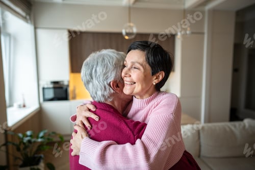 Preview: Cheerful happy senior couple hugging celebrating achievement. Happy wife in arms, promotion recovery