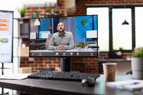 Preview: Close up of video call conversation with colleague on monitor