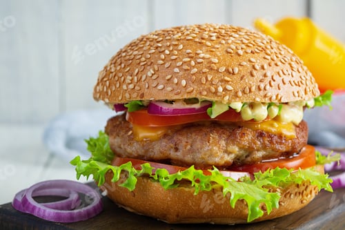 Preview: Homemade classic hamburger with beef cutlet, cheese, lettuce and tomato on wooden background