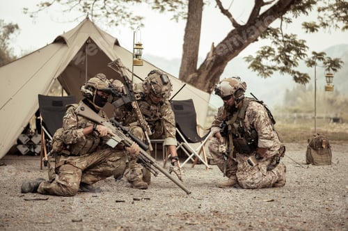 Preview: Soldiers in camouflage uniforms planning on operation in the camp