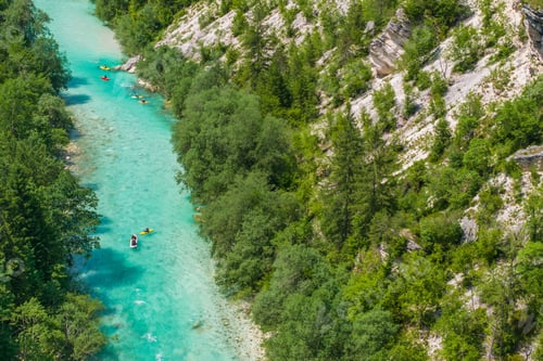 Preview: Kayakers Exploring Turquoise Waters of the Soca River in Lush Valley Near Mountain Landscape