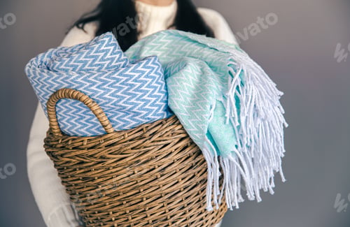 Preview: Textured plaids in a wicker basket on a gray background.