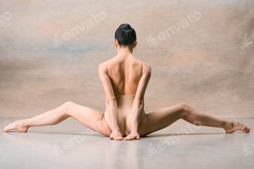 Preview: The ballerina is sitting with her back legs wide apart