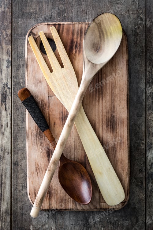 Preview: Wooden kitchen utensils resting on rustic cutting board
