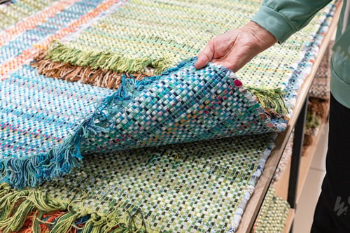 Preview: A woven rug made of old things. Eco-friendly development. Reuse of items. Handmade work.