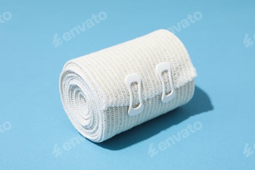 Preview: Concept of help during an injury, elastic bandage on blue background