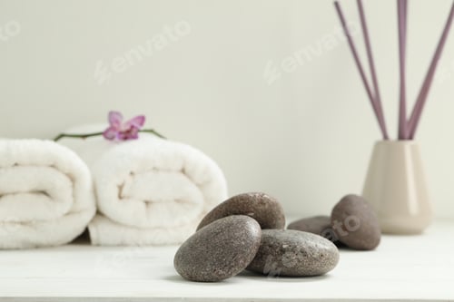 Preview: Pile of spa stones on white wooden table