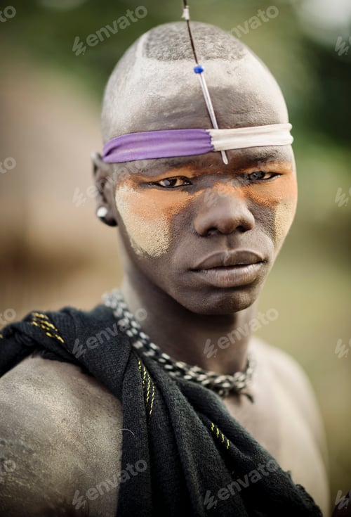 Preview: Portrait of a young man in traditional tribal attire with face paint