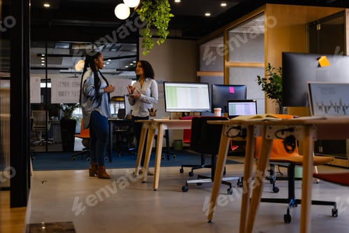 Preview: Diverse female colleagues in discussion in casual office meeting