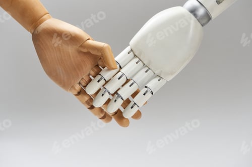Preview: Wooden doll and robot handshaking isolated on grey