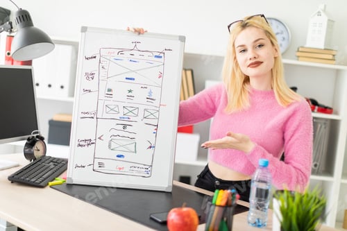 Preview: Young girl standing in the office and holding a magnetic Board.