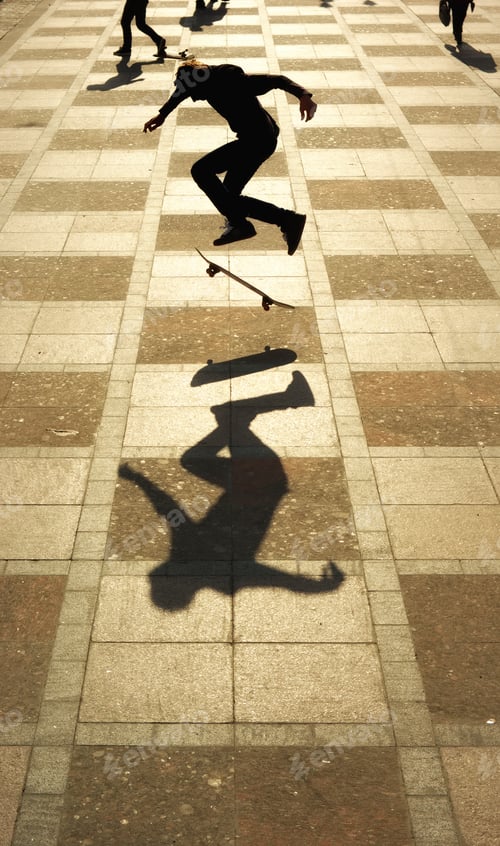 Preview: Silhouette of skateboarder at town