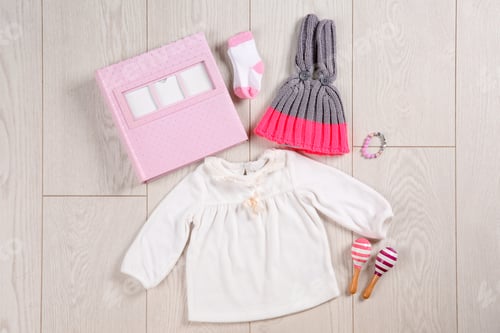 Preview: Flat lay composition with stylish child clothes and accessories on wooden background