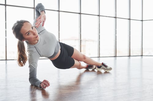 Preview: Exercises for strength and stamina. Sportive young woman have fitness day in the gym at morning time