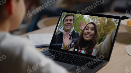 Preview: Young parents calling kid in videochat closeup. Smiling woman waving in screen
