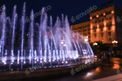Preview: Blurred view of beautiful city at night. Bokeh effect