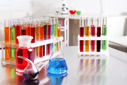 Preview: Laboratory glassware with color liquids on table. Solution chemistry