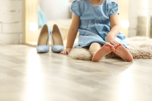 Preview: Cute little girl sitting on floor at home, closeup