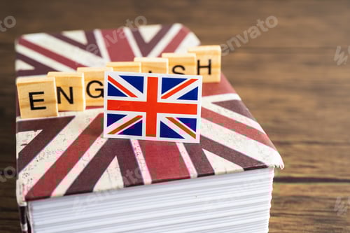 Preview: Word English on book with United Kingdom flag, learning English language courses concept.