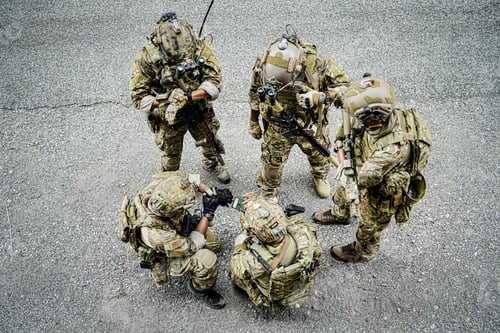 Preview: Soldier in full US MARSOC armed with assault rifle run through the abandoned building. Military