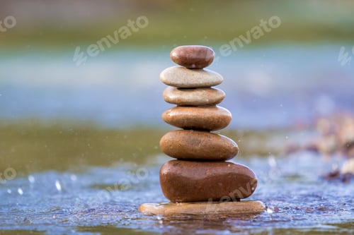 Preview: Close-up abstract image of wet rough natural brown uneven different sizes and forms stones balanced