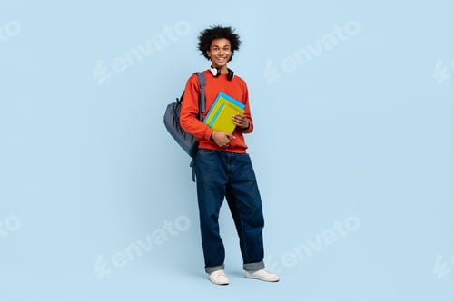 Preview: Young man with books and backpack