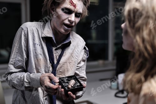 Preview: Zombie man showing cut thumb to female