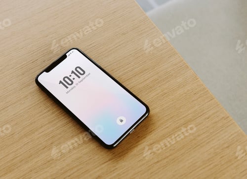 Preview: Mobile phone showing date and time on a wooden table