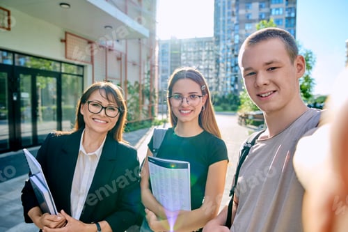 Preview: Selfie portrait female teacher with teenagers students, outdoors