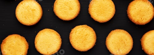 Preview: Homemade Pure Butter Shortbreads on a black background, top view. Flat lay, overhead, from above.